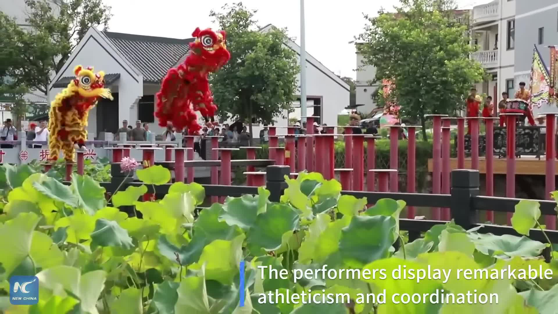 Poles and precision Chinese lion dancers perform above water